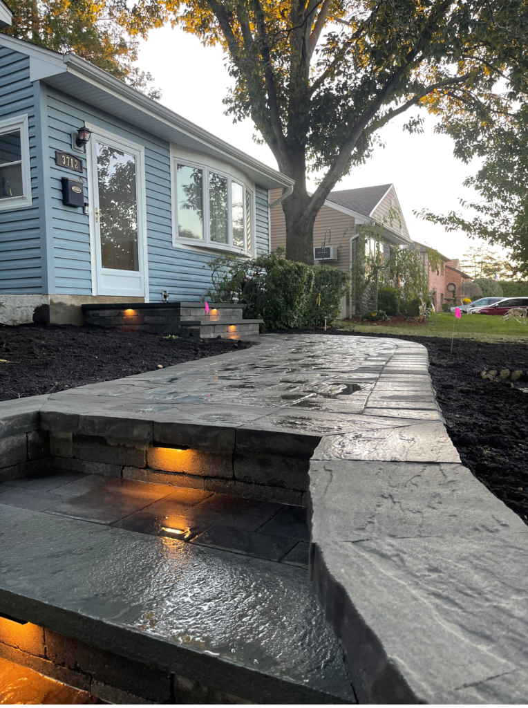 front entry design with stone paver steps and lights