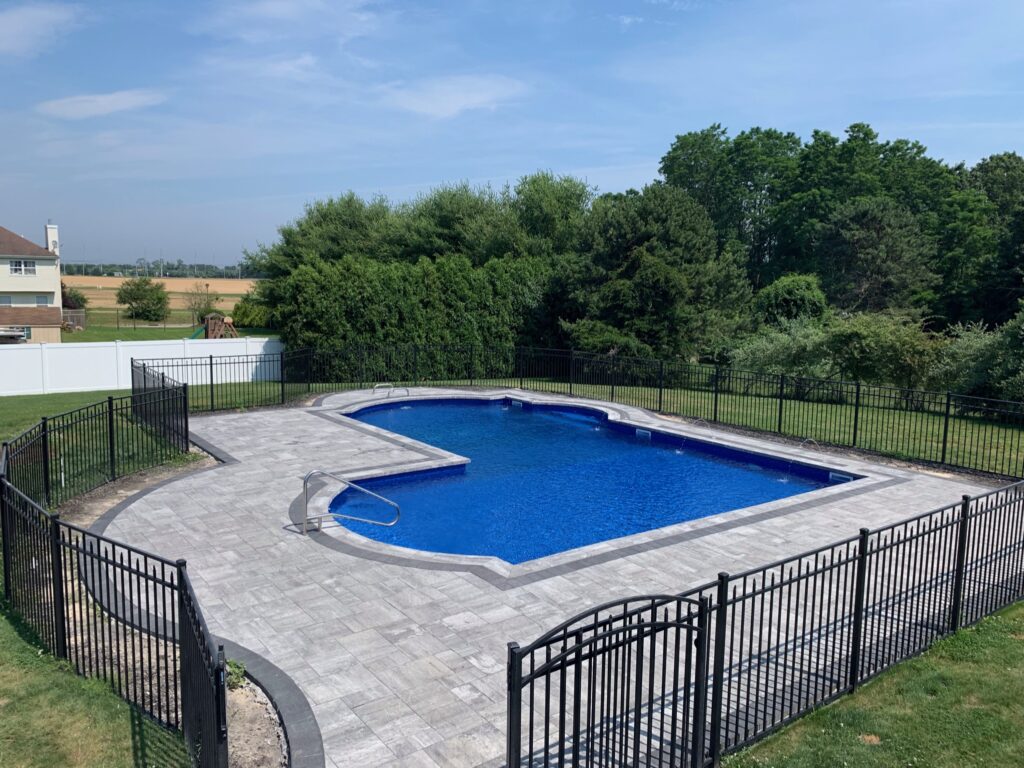 paver pool patio and coping installation, fenced in backyard pool with paver patio